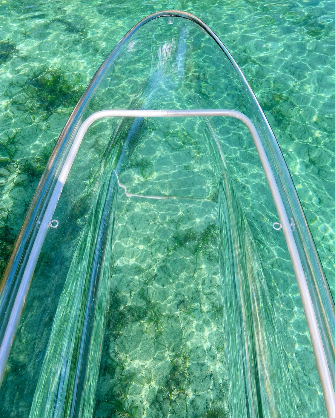 View through a crystal clear kayak into the clear spring water of the Silver River at Silver Springs